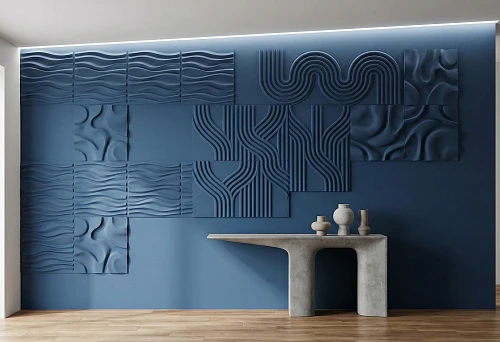 Modern stucco molding on the wall: contemporary 3D panels with waves and geometry on a blue accent wall with soft lighting.