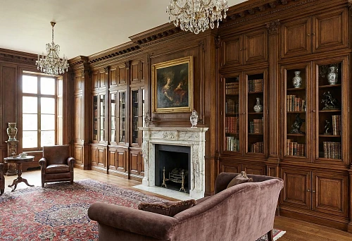 Classic living room with built-in solid wood cabinets and library, wooden panels, marble fireplace, crystal chandeliers, and carpet