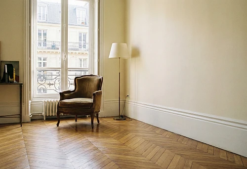 Wooden floor skirting board wide white: European style in a room with herringbone parquet and a high window