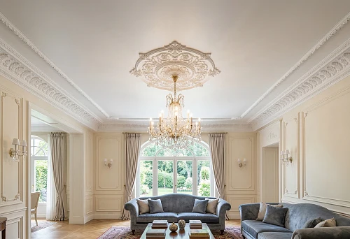 Stucco molding on a stretch ceiling in a classic living room with a central rosette for a chandelier and an elegant ceiling cornice
