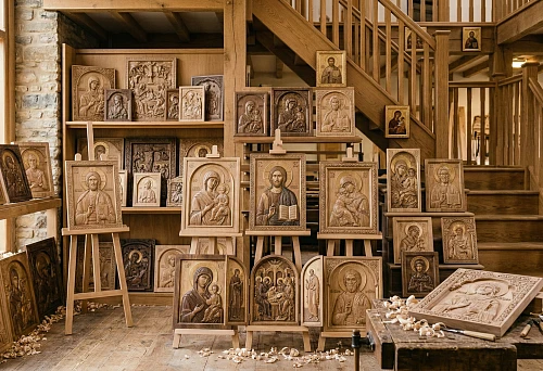 Carving workshop: carved wooden icons on easels and shelves, relief work