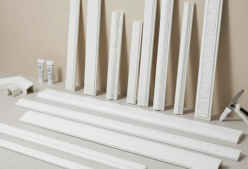 Polyurethane moldings of various profiles, laid out for installation, with examples of joints and elements for precise fitting.