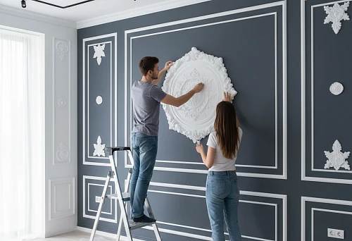 Installation of polyurethane decorative wall element by two people