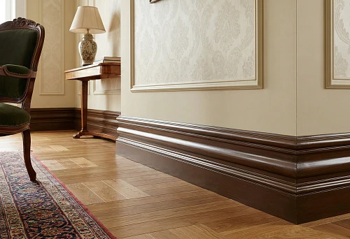 Wide shaped wooden baseboard in the living room: classic profile and dark finish near the parquet