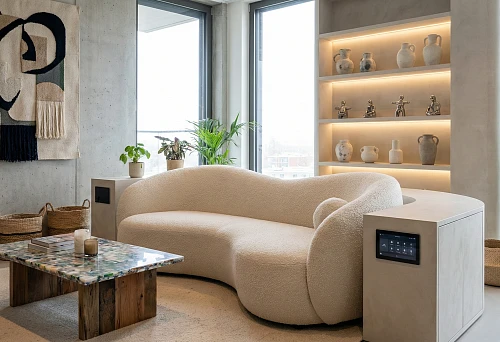 Modern living room: modular boucl&eacute; sofa and built-in touch control panel in the cabinet near the armrest