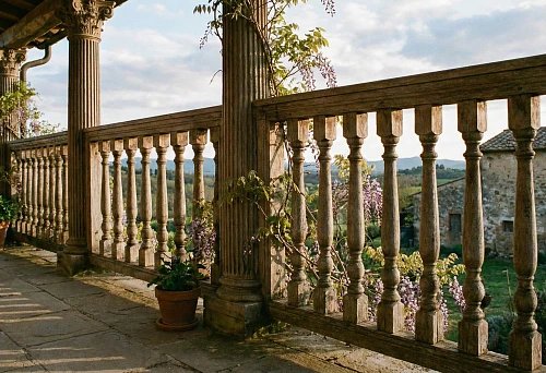 Wooden balustrade with turned balusters on terrace of country house in classic style