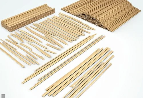 Set of wooden planks of various lengths and thicknesses on a light background