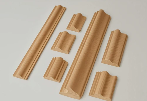 Set of narrow wooden strips with carved profiles and decorative edges