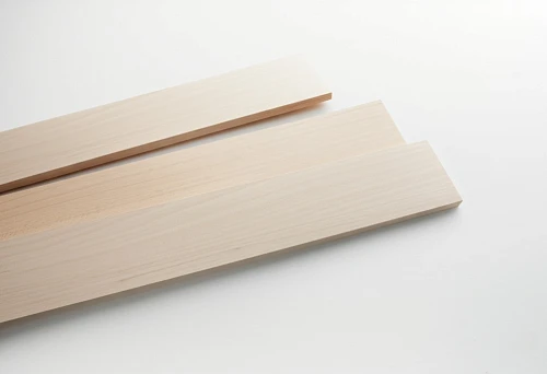 Three Light Wooden Planks of Different Widths on a White Background