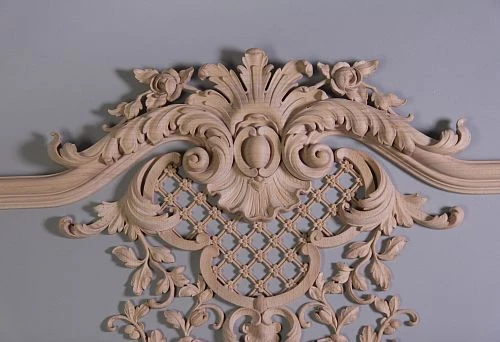 Decorative carved inlay of light wood with floral and botanical motifs