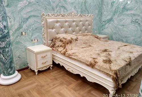 Luxurious bedroom with carved bed and bedside tables