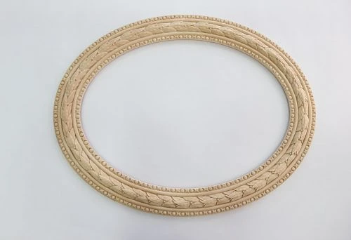 Oval carved frame made of natural wood with a classic pattern