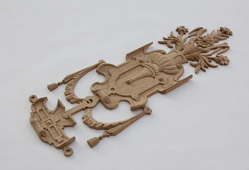 Carved decorative wooden element with floral ornament &mdash; example of unique decoration for furniture and interior.