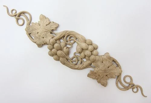 Carved wooden applique with grapevine for wall framing