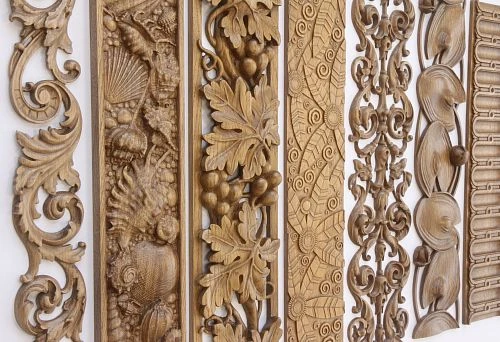 Collection of carved decorative wooden elements with ornamental and botanical motifs for decorating doorways and walls in interiors