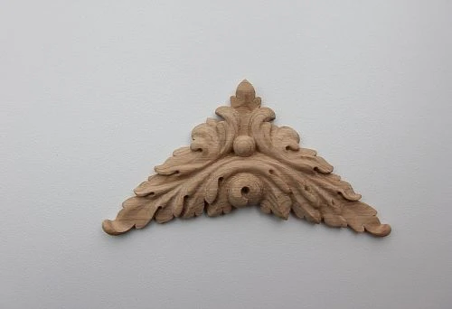 Carved wooden applique in classic style with leaf and scroll ornament.