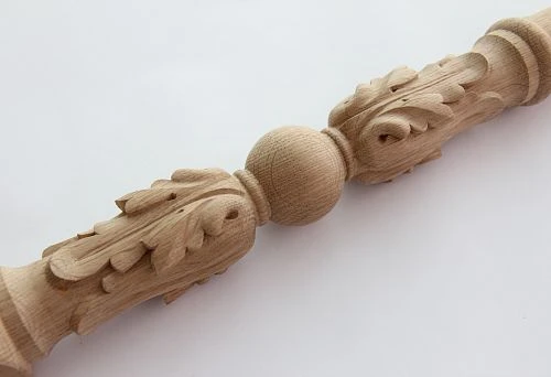 Carved wooden baluster with relief leaf ornament and central round shape