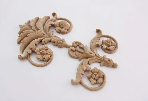 Elegant carved wooden ornament with floral motifs and smooth lines.