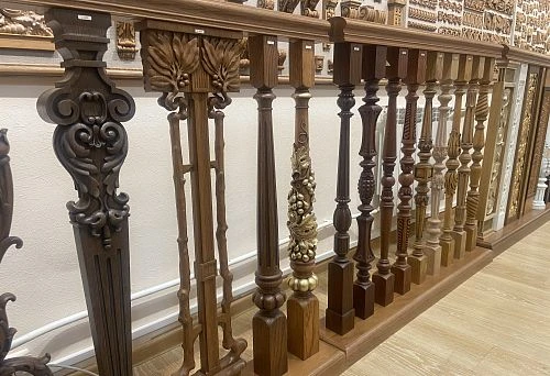 Collection of carved wooden columns and balusters for staircases, crafted in classic and decorative styles.