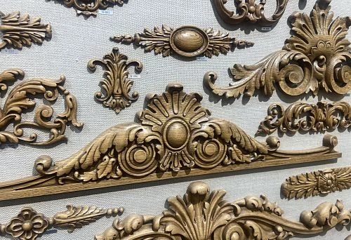 Decorative carved wooden ornaments in classic style, crafted with fine detailing.