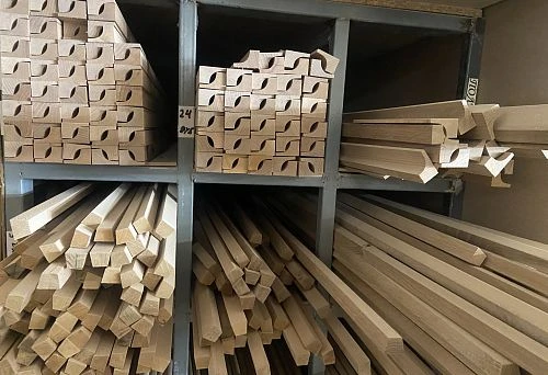 Set of wooden baseboards and moldings, arranged in storage compartments
