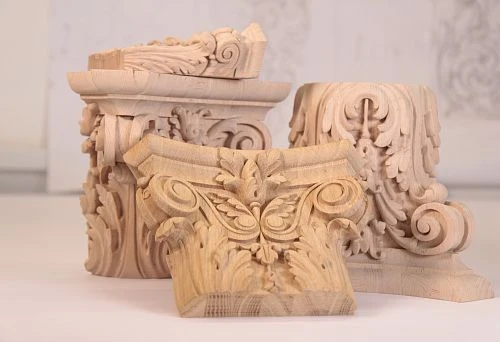 Carved decorative capitals and elements from natural wood for decorating a unique interior
