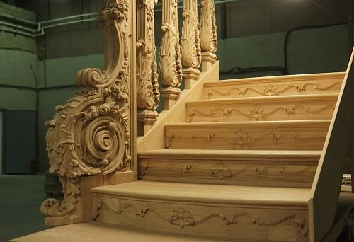 Luxurious Wooden Staircase with Carved Posts and Decorative Elements