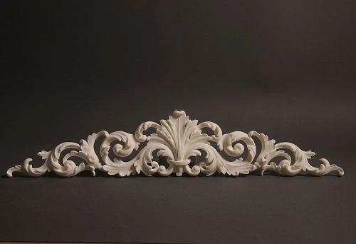 Carved wall ornament with curved lines and scrolls