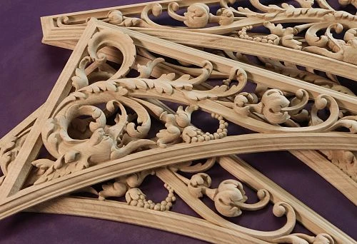 Complex carved wooden details with floral ornamentation, executed in classical style.