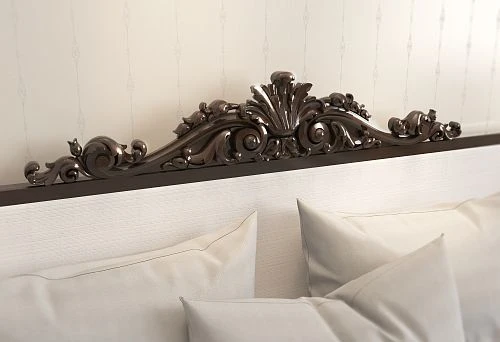 Carved headboard with an elegant classic pattern, creating an atmosphere of luxury and comfort in the bedroom.