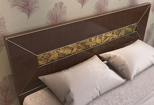 Close-up of a bed headboard with dark wood finish and decorative inlay with gold pattern