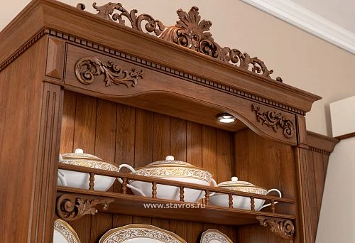 Fragment of a wooden cabinet with carved decoration, stained or lacquered, classic handcrafted ornament