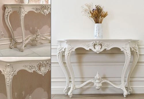 White carved console table with decorative elements and curved legs