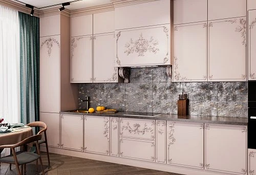 Kitchen with classic-style facades, decorative elements, and a countertop imitating natural wood, against a gray-glossy backsplash.