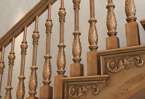 Carved wooden balusters and handrail in classic style on the staircase