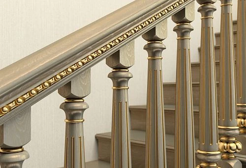 Classic wooden staircase supports with decorative carving and gold trim
