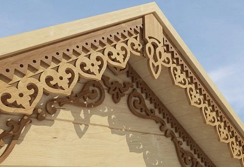 Carved moldings in Russian style on the facade of the house, made of light wood.
