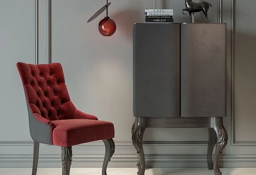 Modern chair with soft velvet upholstery and carved wooden legs against a minimalist interior