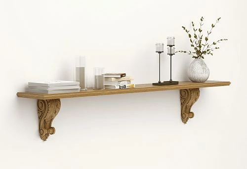 Wall-mounted solid wood shelf with carved brackets, decorated with books, candles, and a vase