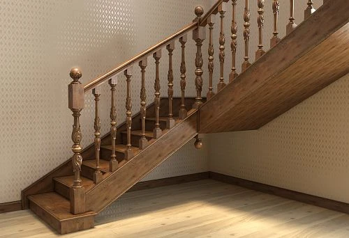 Staircase with installed wooden railings and carved balusters in a classic interior
