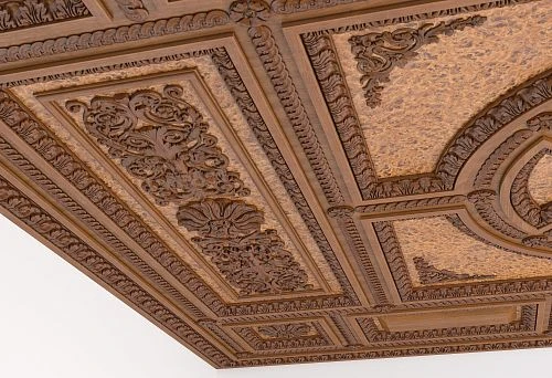 Elegant wooden ceiling with carved inserts and borders.