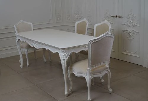 Carved leg decor for wooden table with delicate patterns.