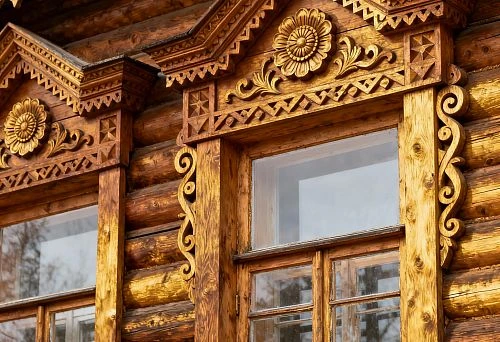 Carved facade decor for windows of a wooden house