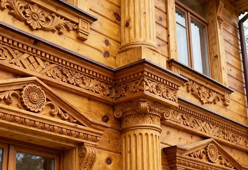 Wooden Facade Decor with Carved Columns and Architraves