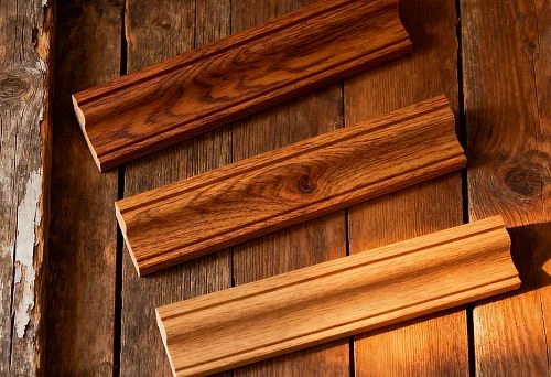 Wooden molding &mdash; three strips of different sizes and shades (20&times;40, 10&times;30, 10&times;40) against an old wooden table background