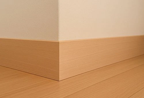 Straight light oak skirting board with smooth surface in modern interior