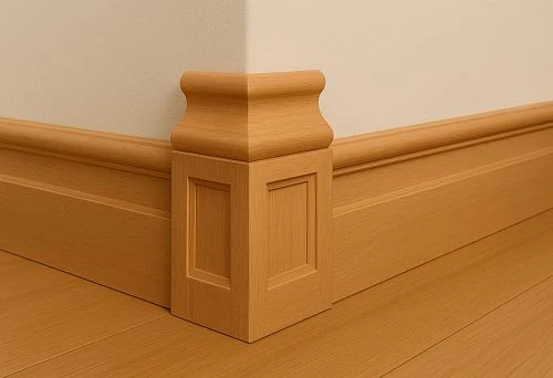 Oak skirting board with decorative molded top and carved panels on an angular decorative post in the interior