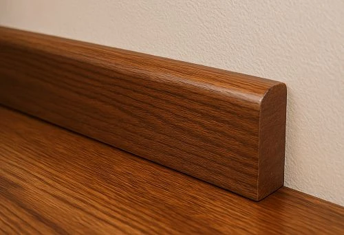 Dark solid oak skirting with rounded top in a modern interior