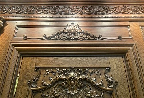 Decorative wooden doorway framing with carved ornament in classical style