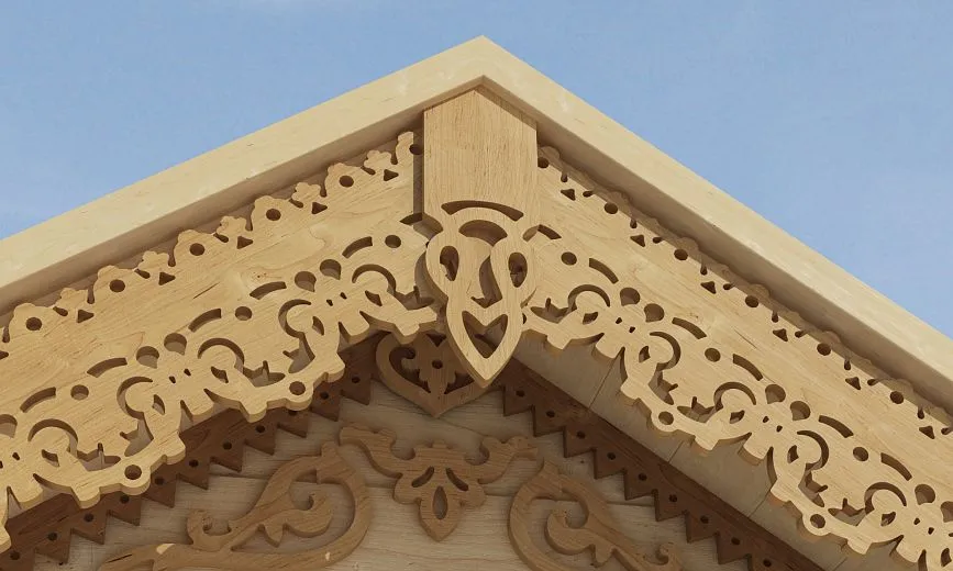 Close-up of an ornate carved decoration on the roof ridge.